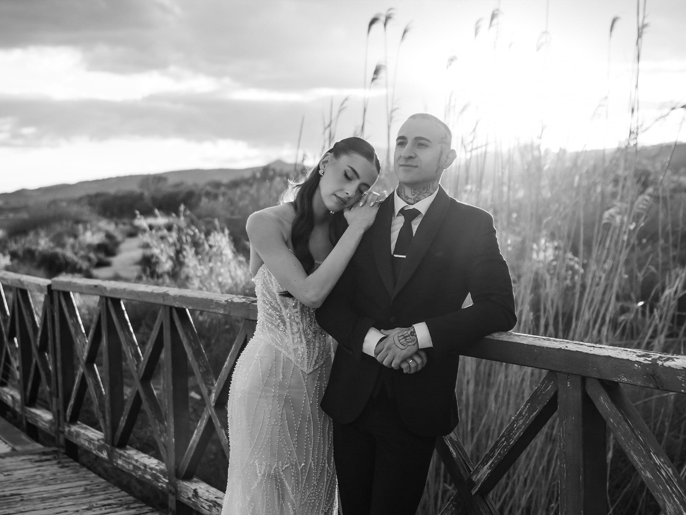 Bride resting her head on the groom's shoulder, black and white